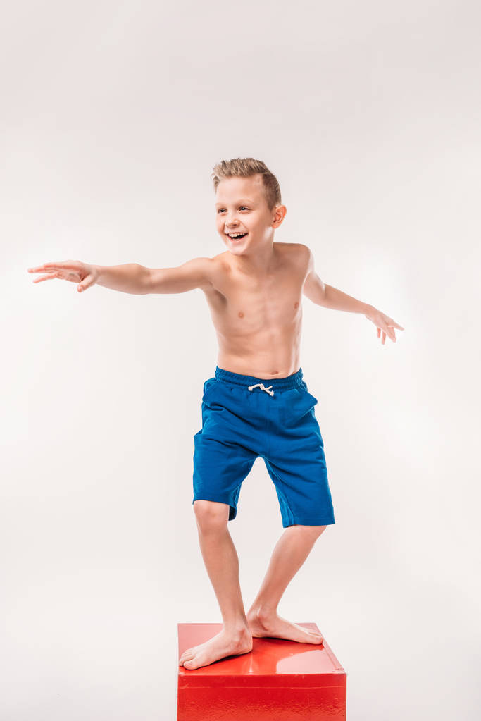 excited boy pretending to be a surfer, isolated on white - Photo, Image
