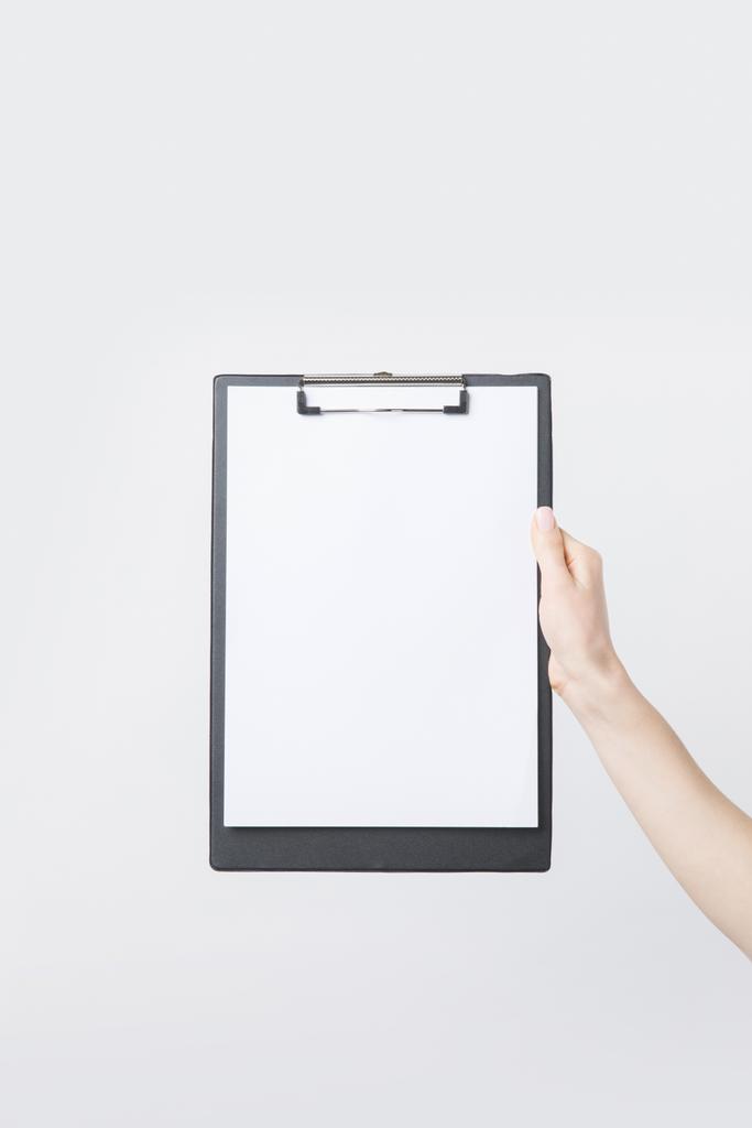 partial view of woman holding blank clipboard in hand isolated on white - Photo, Image