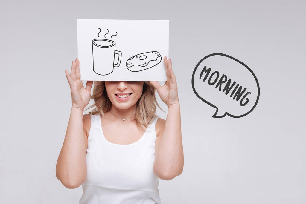 Good morning. Positive young cheerful woman feeling optimistic and having a pleasant morning with tasty breakfast - Photo, Image