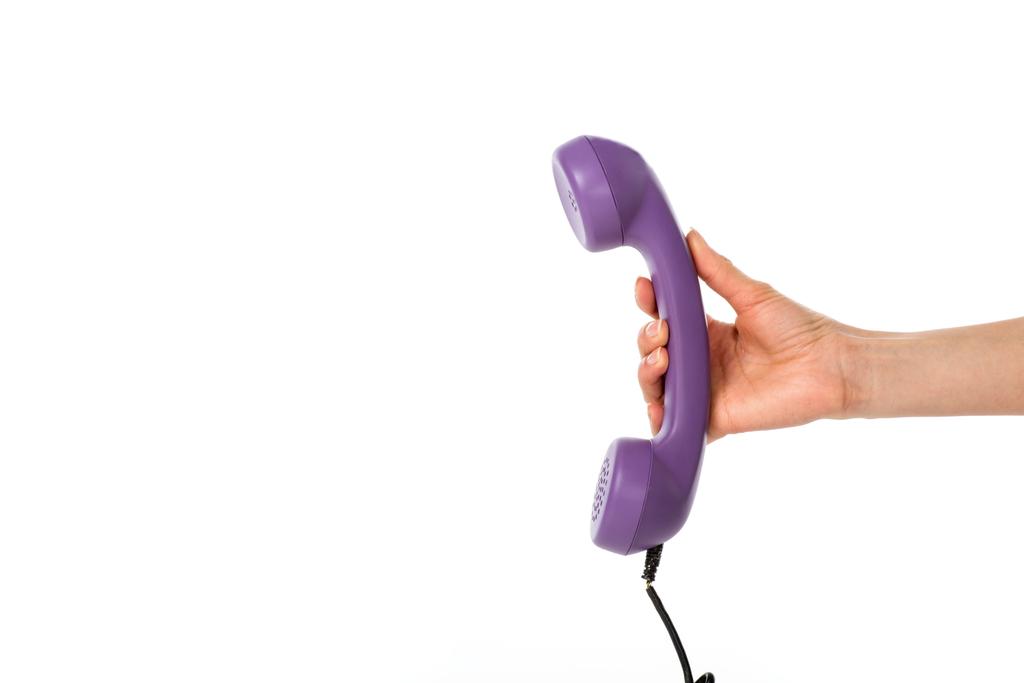 cropped shot of woman holding purple telephone tube in hand isolated on white - Photo, Image
