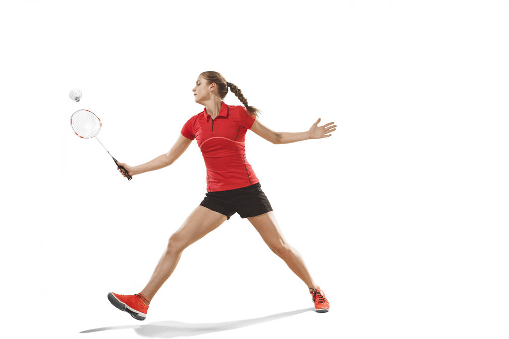 junge Frau spielt Badminton auf weißem Hintergrund - Foto, Bild