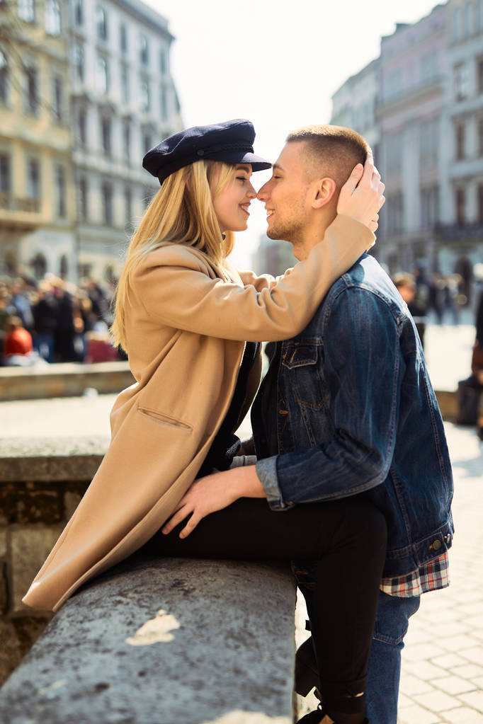 Lovely couple stand on city landscape and hug each other with su - Photo, Image