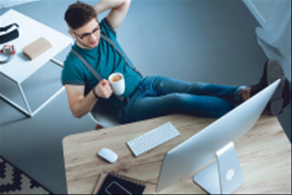 high angle view of young man drinking coffee and working at home office  - Photo, Image