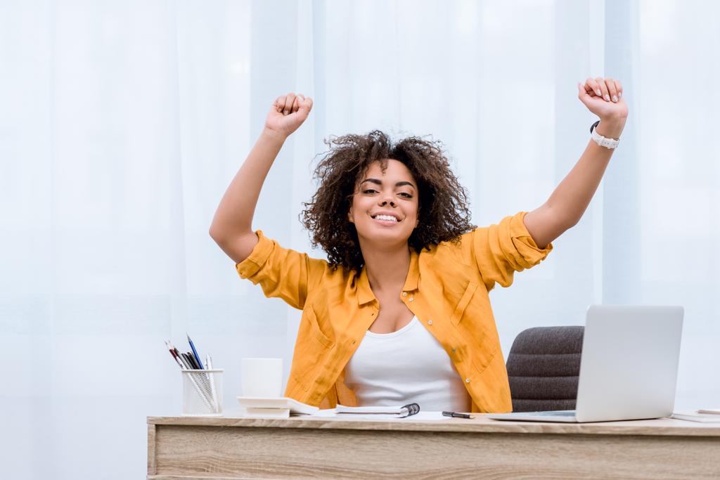 beautiful young woman performing victory dance at workplace - Photo, Image