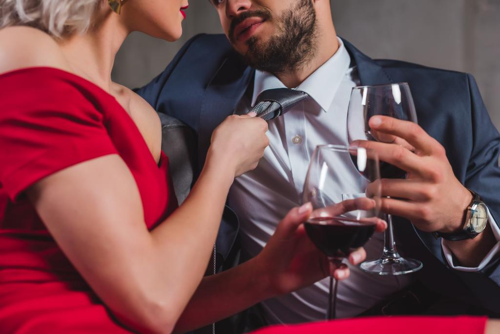 cropped shot of sexy stylish couple drinking wine together - Photo, Image