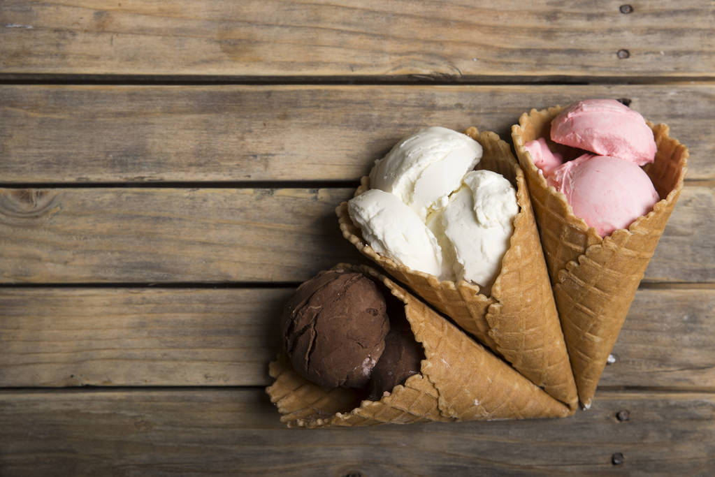 Variety of ice cream scoops in cones with chocolate, vanilla and strawberry - Photo, Image