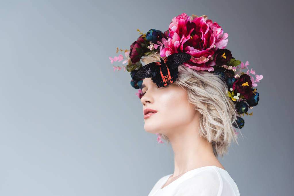 fille à la mode posant en couronne florale avec papillon, isolé sur gris
 - Photo, image