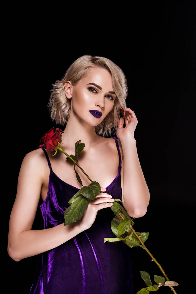 beautiful girl posing in purple dress with red rose, isolated on black - Photo, Image
