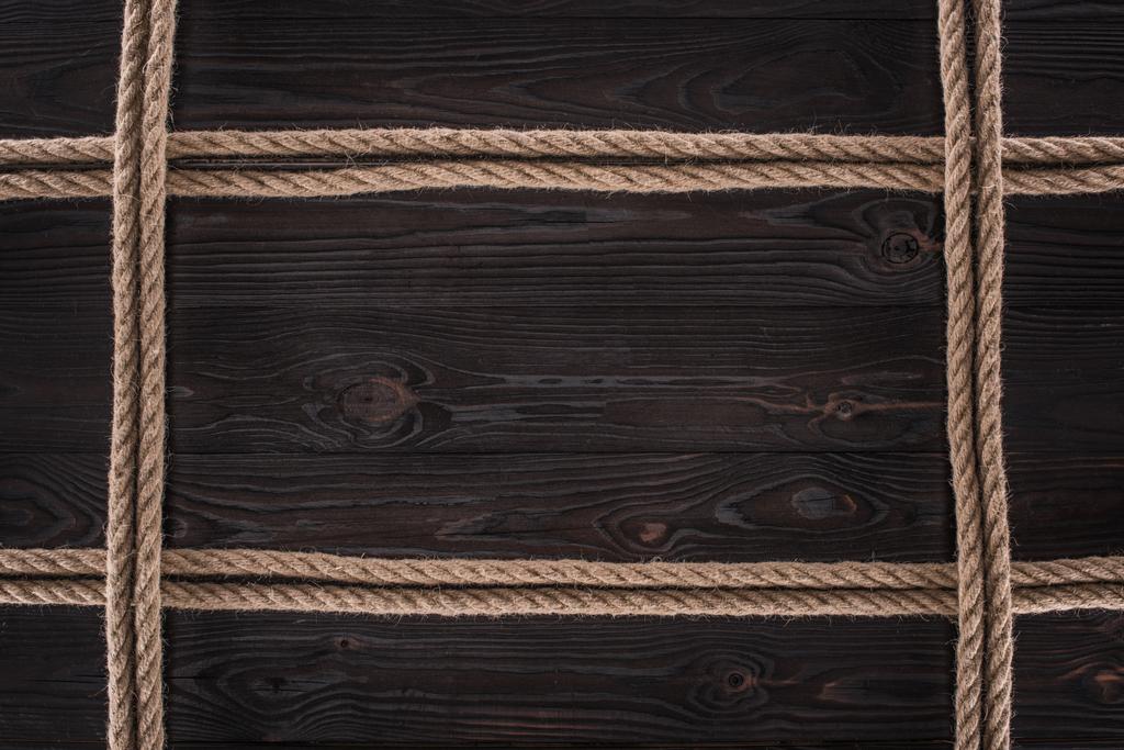 Widok z góry aranżacji brązowy Liny żeglarskie na ciemny blat drewniany - Zdjęcie, obraz