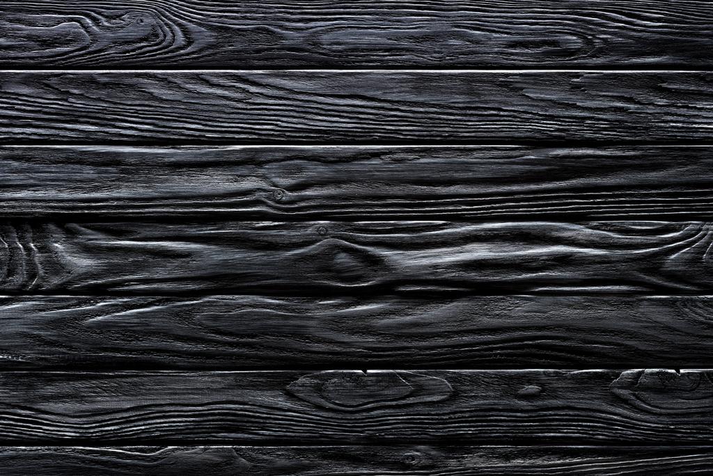 Wooden horizontal planks painted in black background - Photo, Image