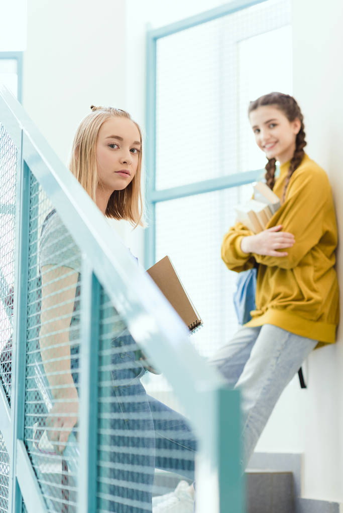 dospívající školačky stojí na schodech a při pohledu na fotoaparát - Fotografie, Obrázek