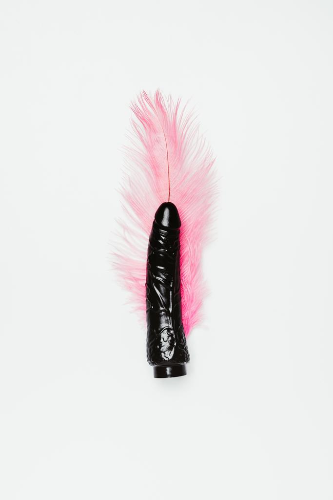 Black dildo toy with pink feather isolated on white - Fotoğraf, Görsel
