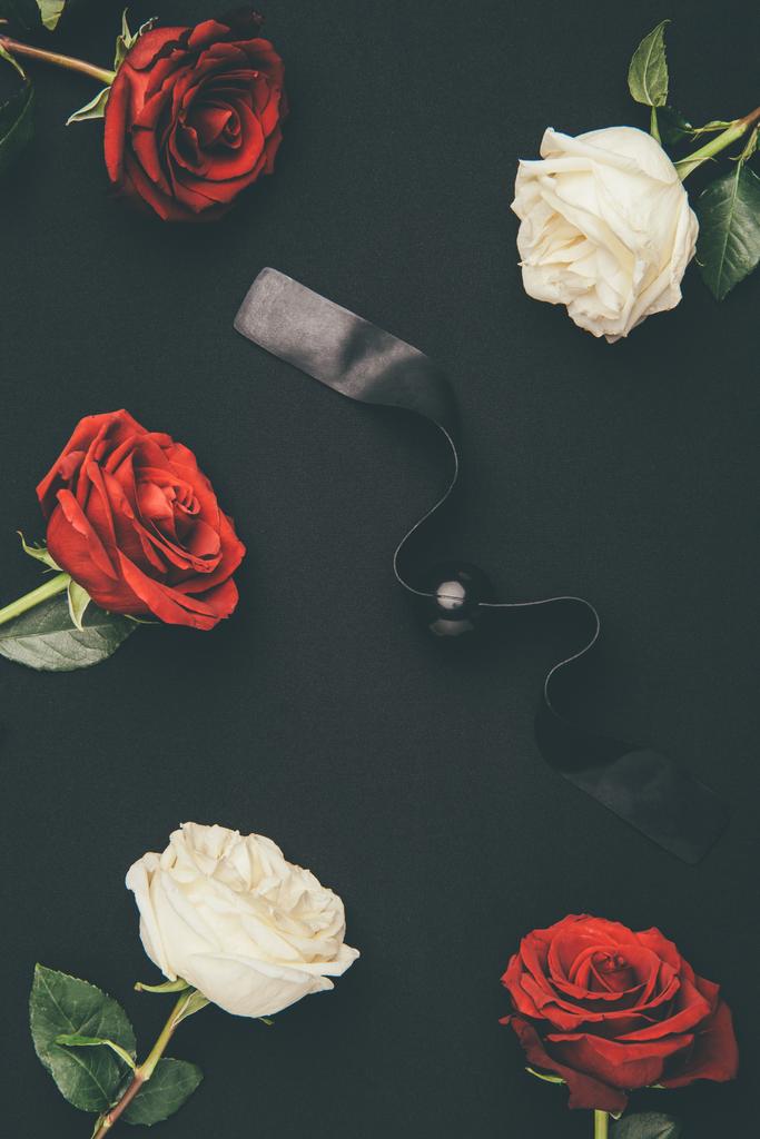 Черный шар кляп с цветами роз изолированы на черный
 - Фото, изображение