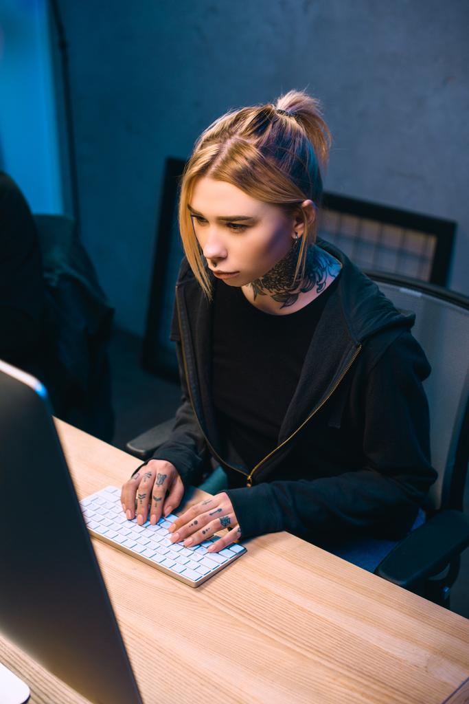 high angle view of serious young female hacker developing malware - Photo, Image