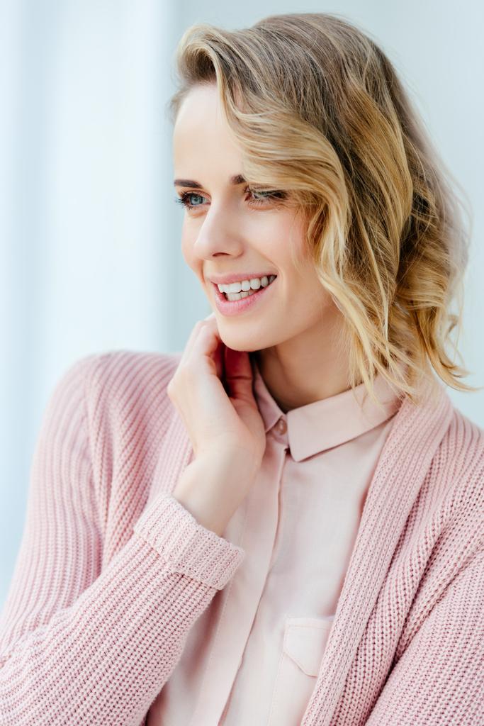 portrait of beautiful smiling woman in pink blouse and jacket looking away - Photo, Image
