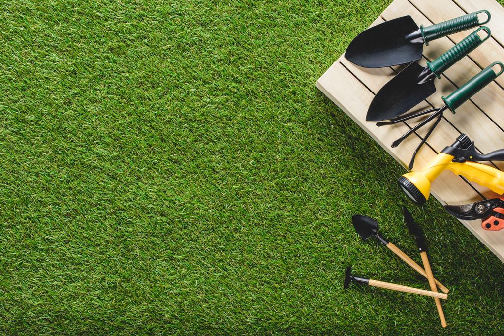 top view of gardening tools and equipment on grass - Photo, Image