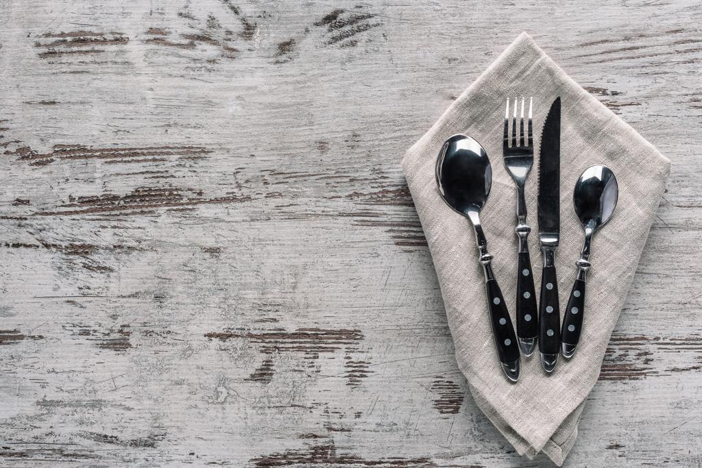 Set of dinner silverware with napkin on wooden table - Photo, Image