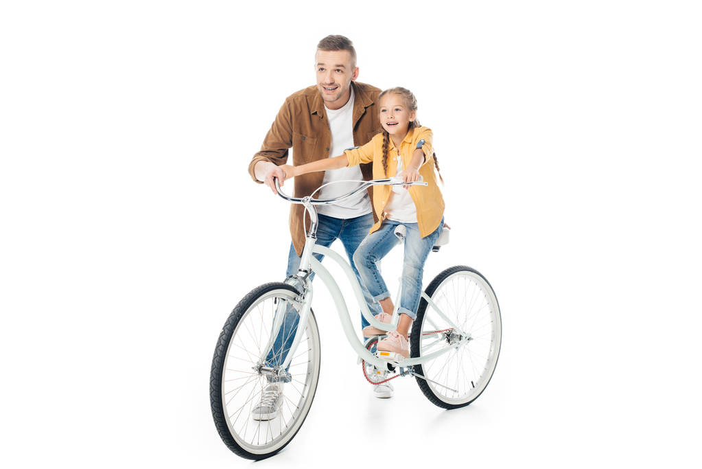 Lächelnder Vater und kleine Tochter auf dem Fahrrad - Foto, Bild