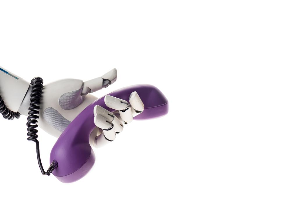 Робот держит фиолетовый стационарный телефон, изолированный на белом
 - Фото, изображение