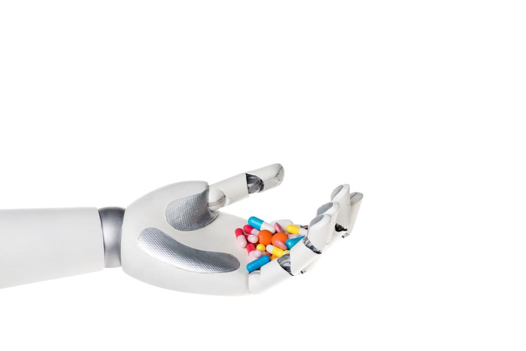 mão robô segurando pílulas diferentes coloridas isoladas no branco
 - Foto, Imagem