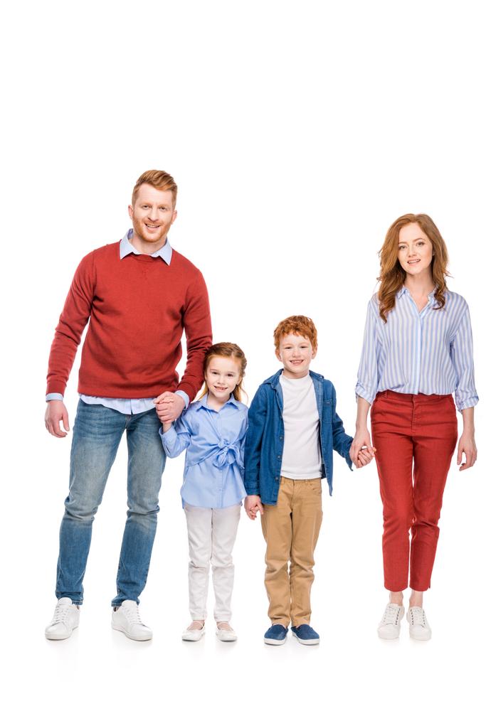 szczęśliwy rude rodziny z dwójką dzieci trzymając się za ręce i uśmiecha się do kamery na białym tle - Zdjęcie, obraz