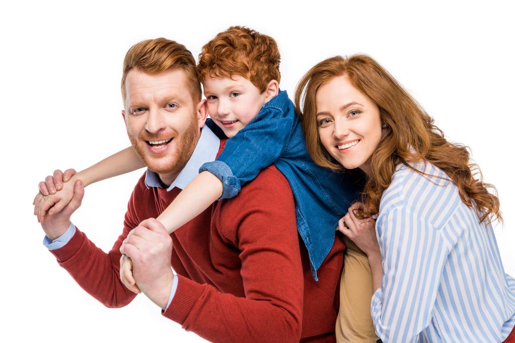happy parents with cute little son smiling and looking at camera isolated on white  - Photo, Image
