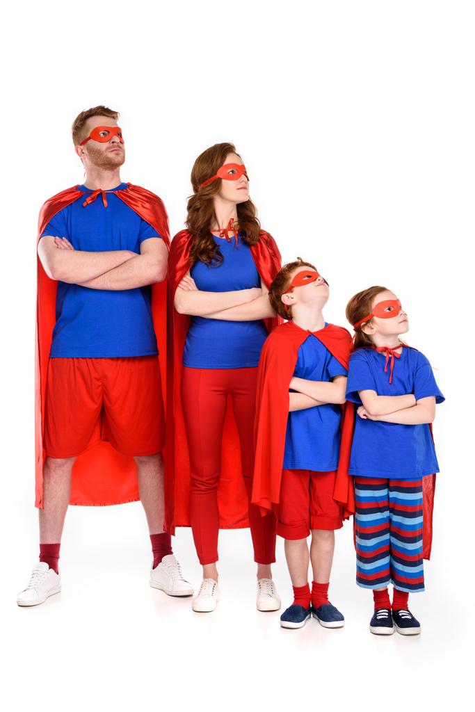 family of superheroes in costumes standing with crossed arms and looking away isolated on white - Photo, Image