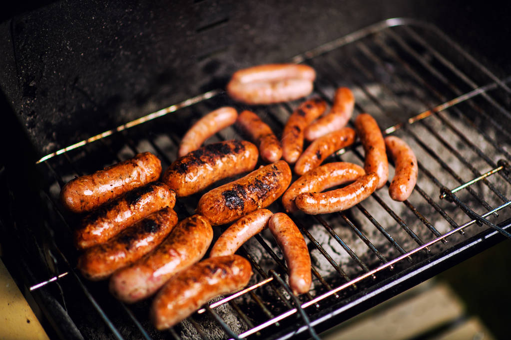 Grilled sausage on the flaming grill - Photo, Image