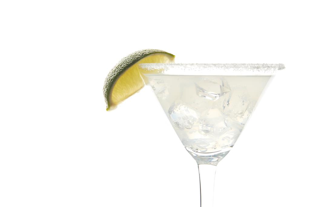 Close up view of margarita cocktail with lime piece and ice isolated on white - Photo, Image