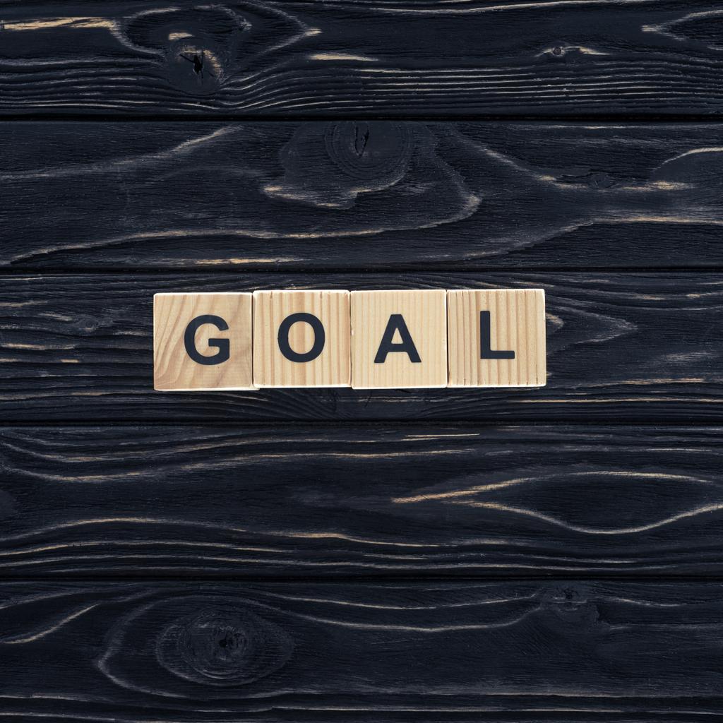 top view of word goal made of wooden blocks on dark wooden tabletop - Photo, Image