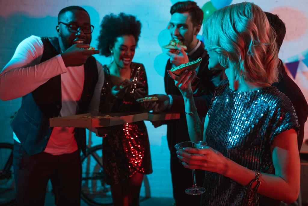 Partying diverse people eating pizza and holding drinks - Photo, Image