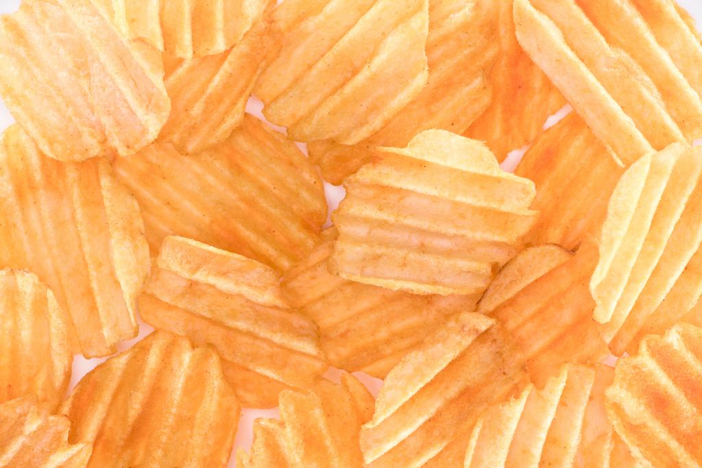full frame view of crispy unhealthy potato chips background on white  - Photo, Image