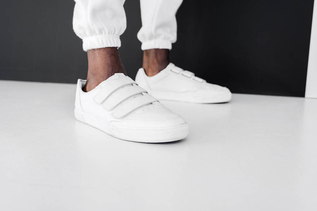 cropped image of stylish african american man standing in white gumshoes - Photo, Image