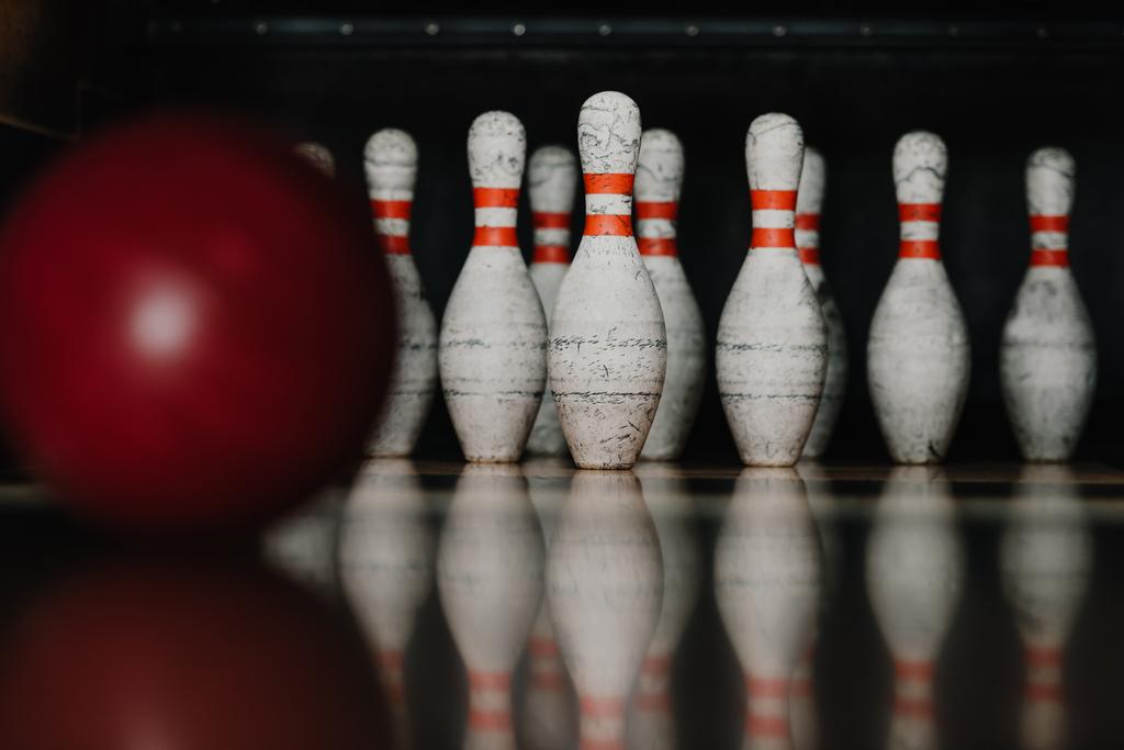 grungy bowling pins with red ball on foreground - Photo, Image