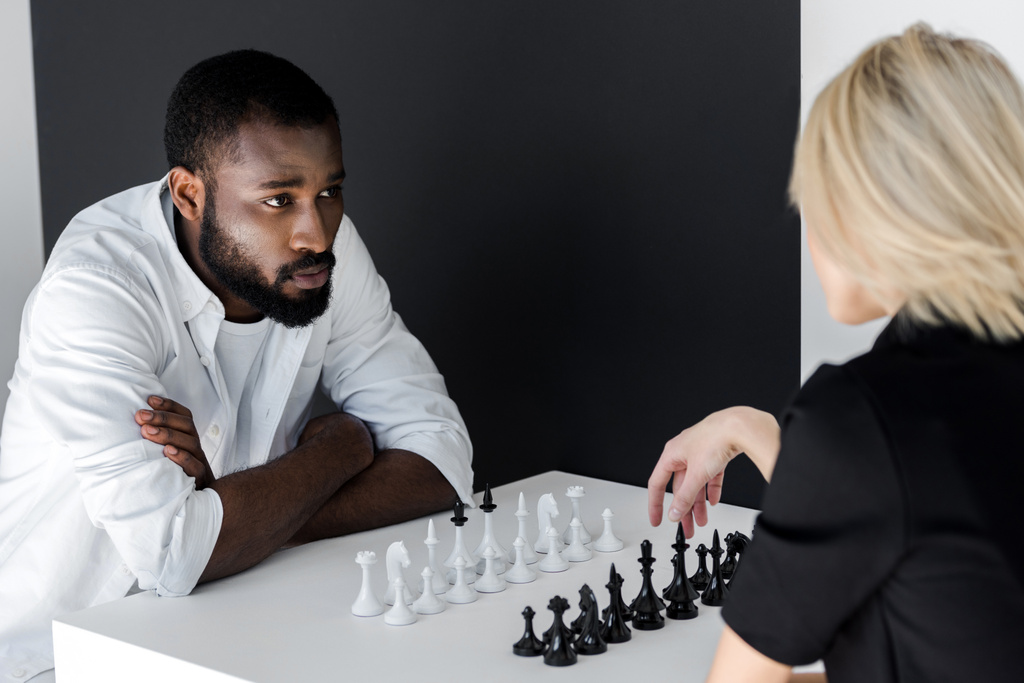 african american boyfriend and blonde girlfriend playing chess, yin yang concept - Photo, Image