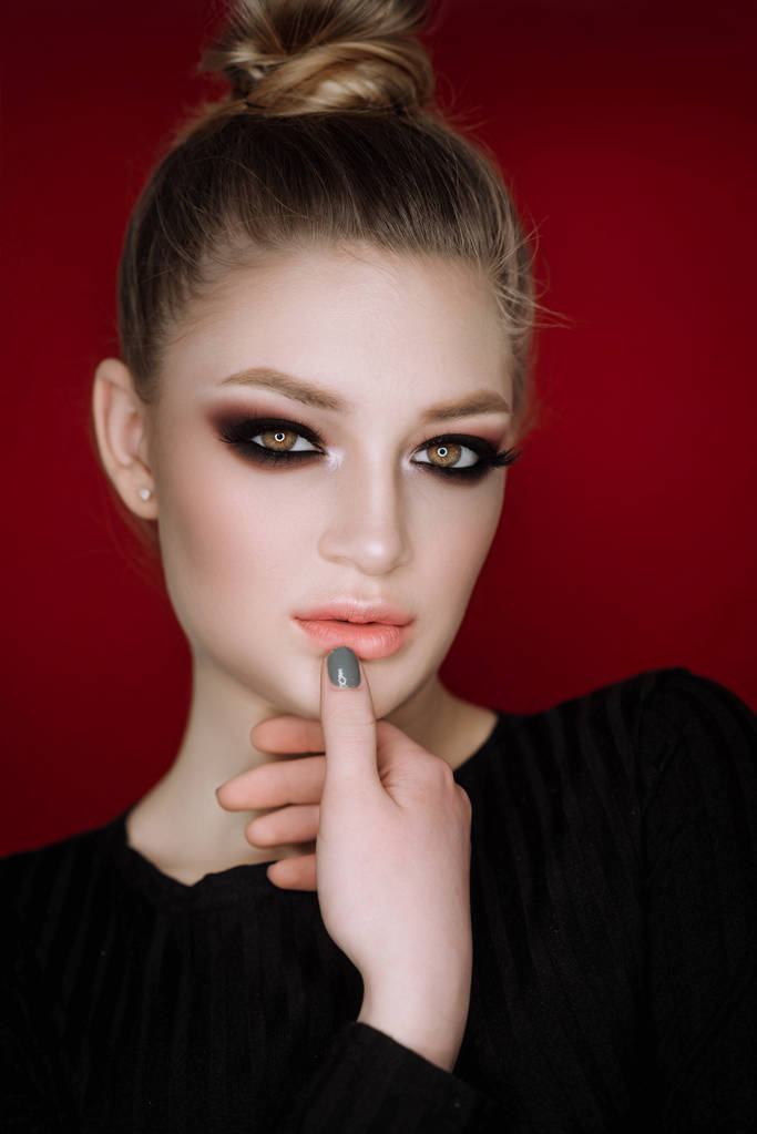 Close up portrait of beautiful young woman with smokey eyes makeup   - Photo, Image