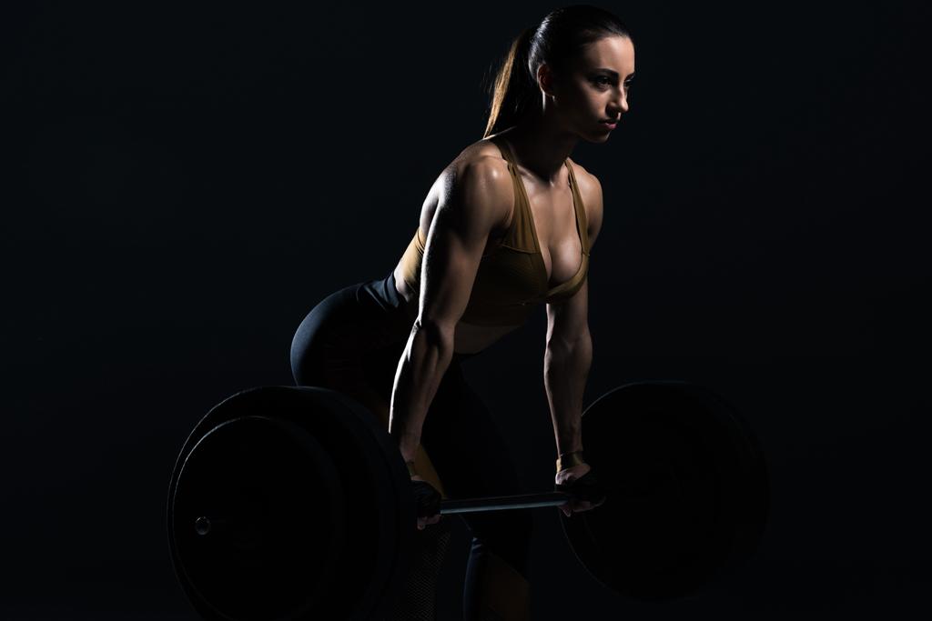 belle haltère haltère bodybuilder féminin, isolé sur noir
    - Photo, image