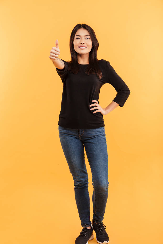Cheerful cute young woman make thumbs up gesture. - Photo, Image