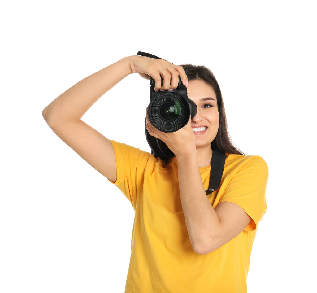 Young female photographer with camera on white background - Photo, Image