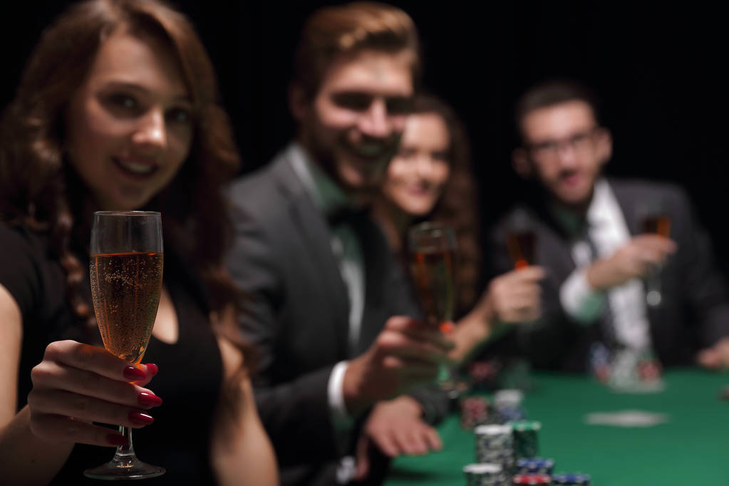 mujer de moda con copas de vino, sentada en una mesa en un casino
 - Foto, imagen