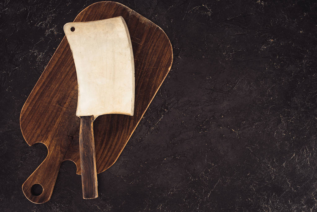 top view of butcher axe on wooden cutting board on marble table - Photo, Image
