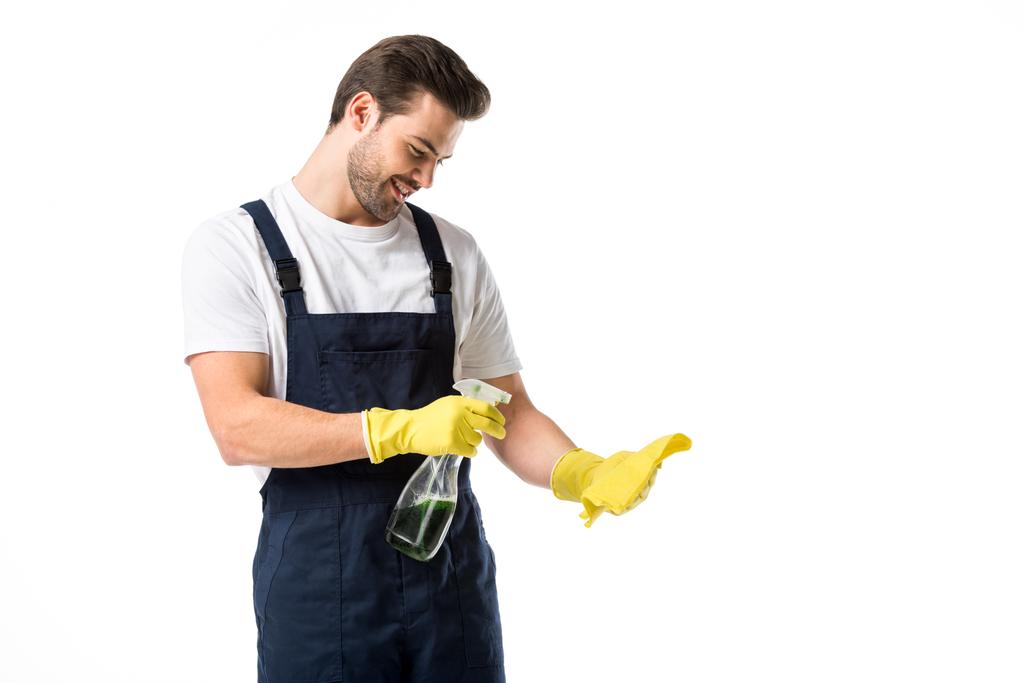 portrait of smiling cleaner in rubber gloves with detergent and rag isolated on white - Photo, Image