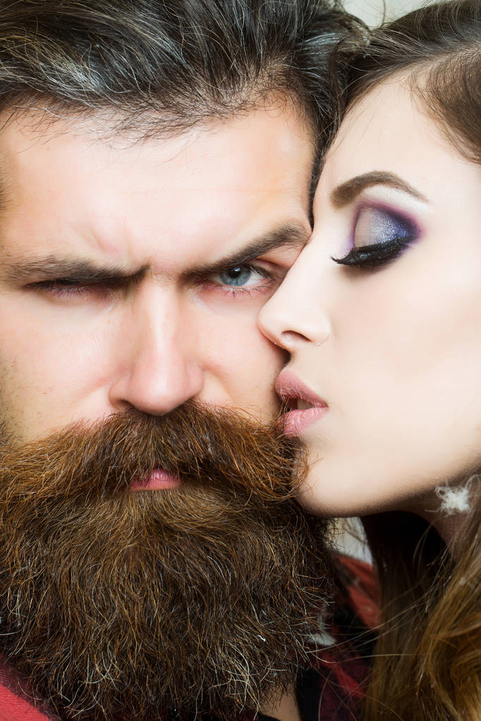 Sensual woman kiss bearded man, love. Woman with makeup skin and hipster with long beard. Couple in love and family concept. Beauty salon and barber shop. Skincare and hair care concept. - Photo, Image
