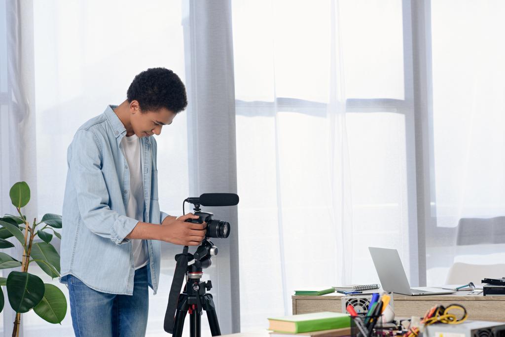 african american teenager setting camera for shooting video blog at home - Photo, Image