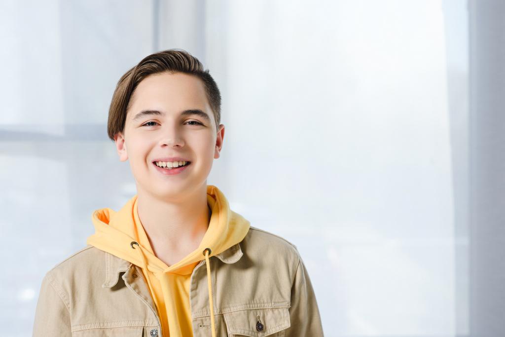 portrait of smiling teen boy looking at camera at home - Photo, Image