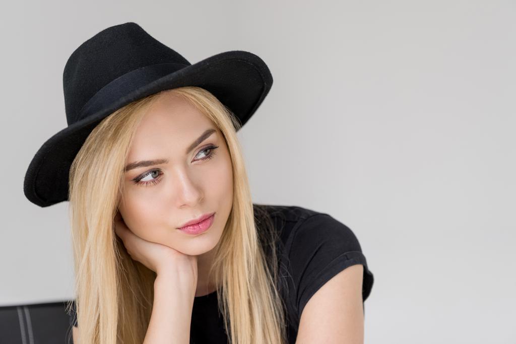 portrait of pensive attractive woman in black hat looking away isolated on grey - Photo, Image