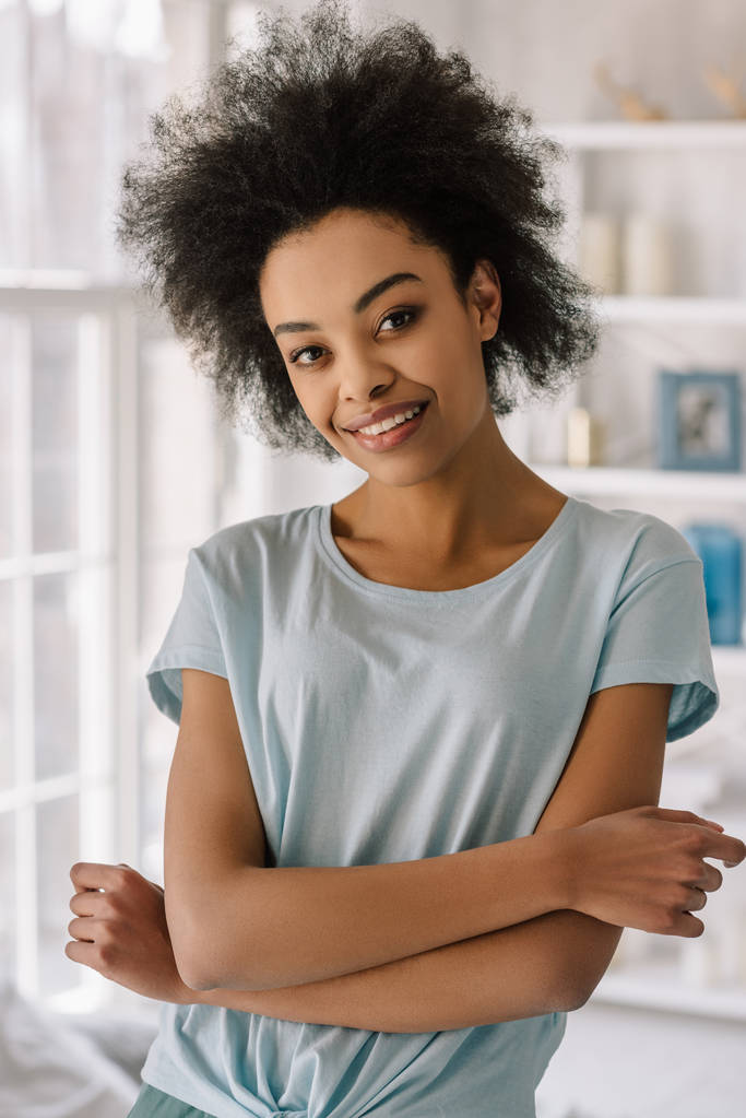 Giovane donna afroamericana sorridente posa a casa
 - Foto, immagini