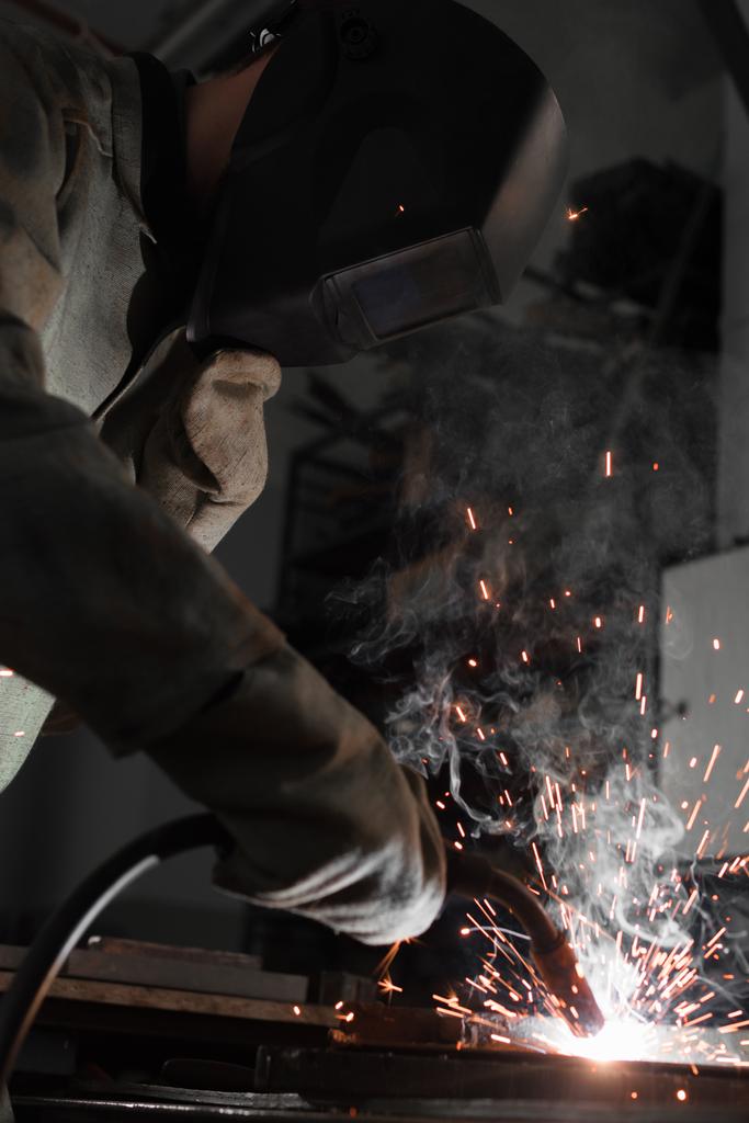 виробництво робітника зварювального металу з іскрами на заводі
  - Фото, зображення