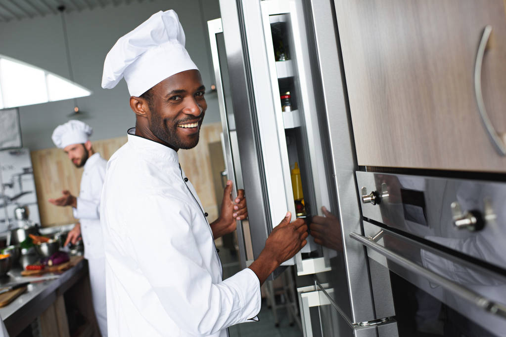 Équipe multiraciale de cuisiniers travaillant sur la cuisine de restaurant professionnel
 - Photo, image