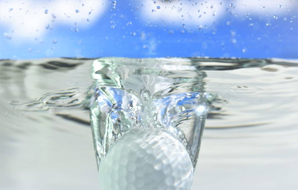 golf ball falling down into water cloud sky background - Photo, Image